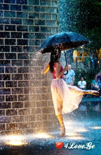 წვიმაში ცეკვავს პატარა ქალი ...